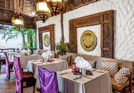 Elegant restaurant interior with decorated tables and Swahili-style decor